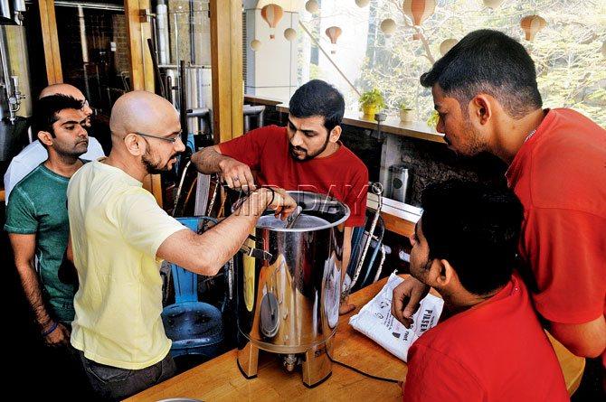 Pratik helps brewmaster Vaibhav as he works the electric beer brewing system. Pic/Datta Kumbhar