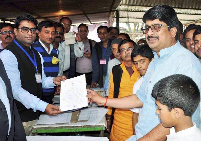 Independent candidate Raghuraj Pratap Singh from Kunda constituency receives the victory certificate after winning the Assembly election, in Pratapgarh on Saturday. Pic/PTI