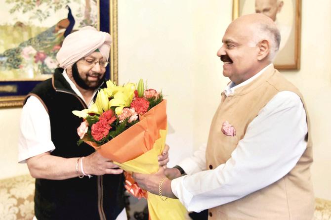 PPCC Chief Captain Amarinder Singh meets Punjab Governor V.P. Singh Badnore at Raj Bhawan in Chandigarh on Sunday. Pic/PTI