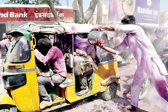 It is Holi in an auto rickshaw in Mathura in Uttar Pradesh yesterday, now we need to watch if the market reflects the celebratory sentiment today. Pic/ AFP
