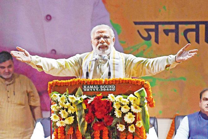 PM Narendra Modi delivers a victory speech at the BJP headquarters in Delhi yesterday, a day after the party scored a landslide victory in UP