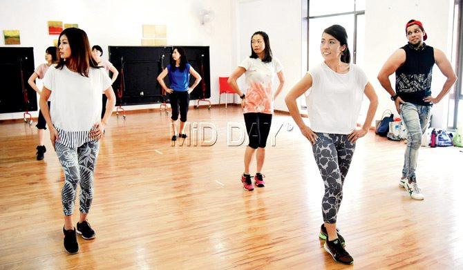 Instructor Satish Vaidya (extreme right) teaches a step to a few members of Spice Madams