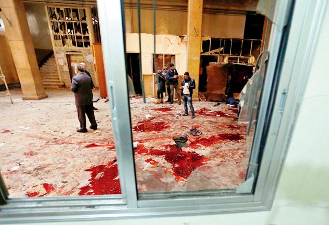 Syrian security forces and journalists stand inside the old palace of justice building in Damascus following the suicide bombing. Pic/AFP