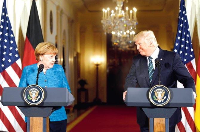 US President Donald Trump and German Chancellor Angela Merkel hold a joint press conference in Washington on Friday. Pic/AFP