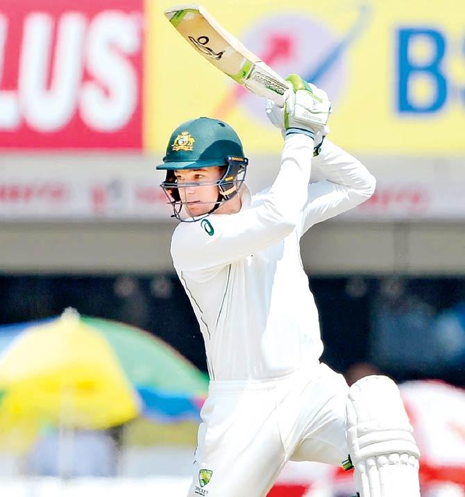 Australia’s Peter Handscomb square drives during his match-saving unbeaten 72 on Day Five of the third Test against India in Ranchi yesterday. Pic/AFP