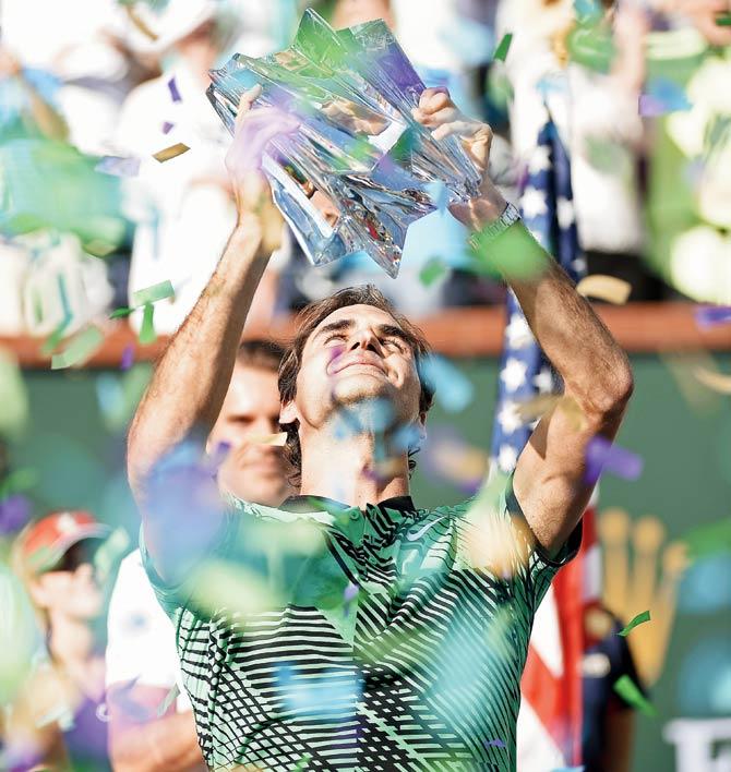 Switzerland’s Roger Federer lifts the winner’s trophy after his 6-4, 7-5 win over compatriot Stanislas Wawrinka in the Indian Wells Masters final at California on Sunday. Pic/AFP