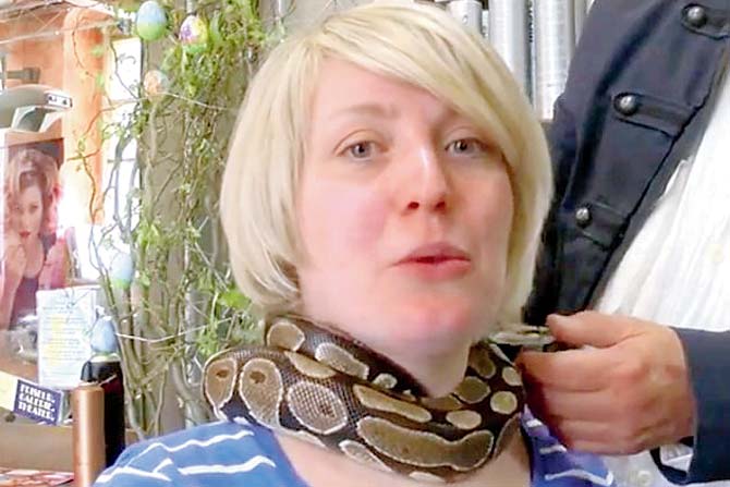 Monty, the python gives soothing massage at a salon in Germany