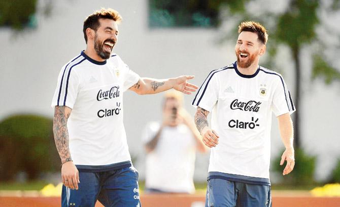 Argentina skipper Lionel Messi (right) shares a light moment with teammate Ezequiel Lavezzi during a training session yesterday ahead of their Friday World Cup qualifier against Chile at Buenos Aires. pic/AFP
