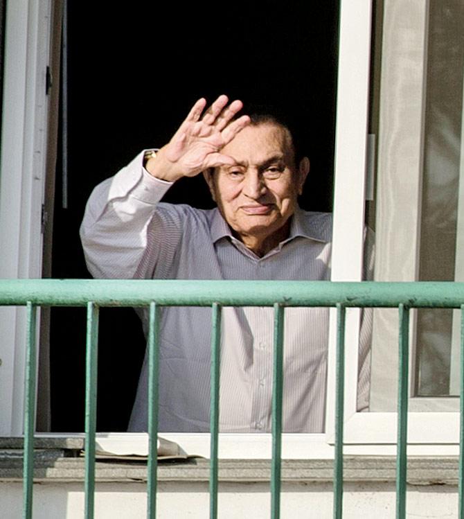 Hosni Mubarak waving to people from his room at the Maadi military hospital last year. Pic/AFP
