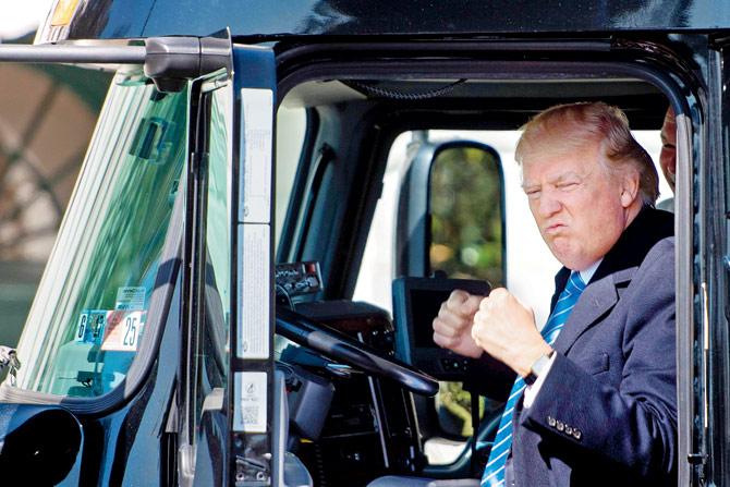 US President Donald Trump sits in the driver