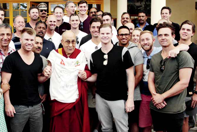 The Dalai Lama (centre) with the entire Aussie team during an interaction in Dharamsala yesterday