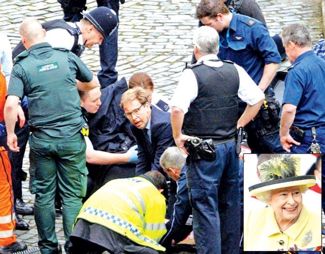 Tobias Ellwood (above, centre) attend to an injured person outside the Houses of Parliament; (inset) Queen Elizabeth. Pic/AFP