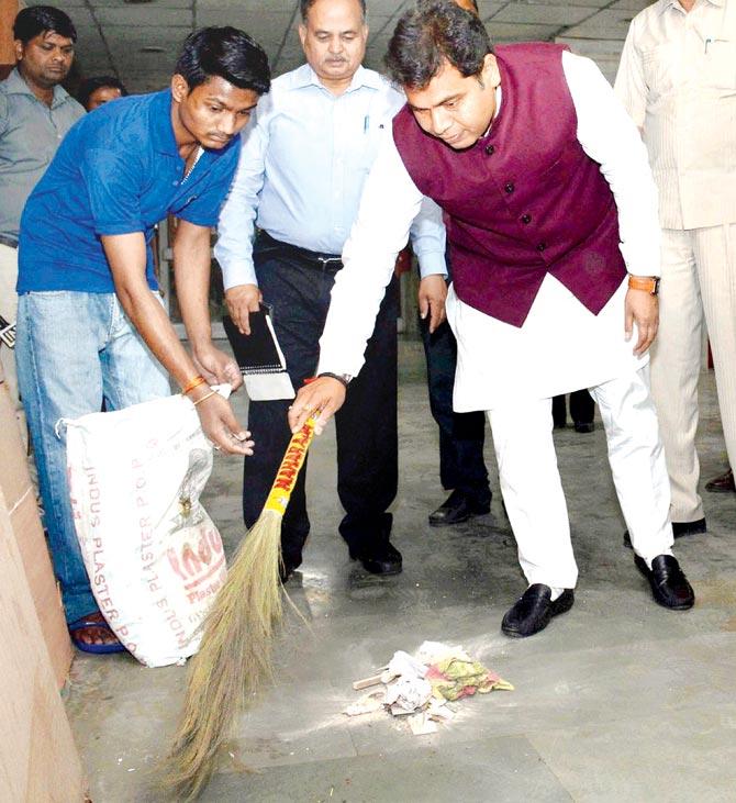 UPâu00c2u0080u00c2u0088power minister Shrikant Sharma cleans the corridor near his office in Lucknow on Friday