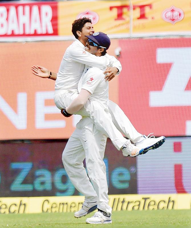Ecstatic Kuldeep Yadav celebrates the wicket of Glenn Maxwell with Umesh Yadav on Day One of the fourth Test against Australia on Saturday. Pic/PTI