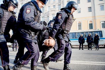 Day after mass protests, Kremlin cracks the whip