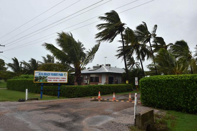 Palm trees blow in the wind in the town of Ayr in far north Queensland as Cyclone Debbie approaches. Pic/ AFP