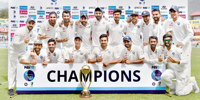 Team India pose with the Border-Gavaskar Trophy after beating Australia by eight wickets in the deciding fourth and final Test in Dharamsala yesterday. Pic/PTI