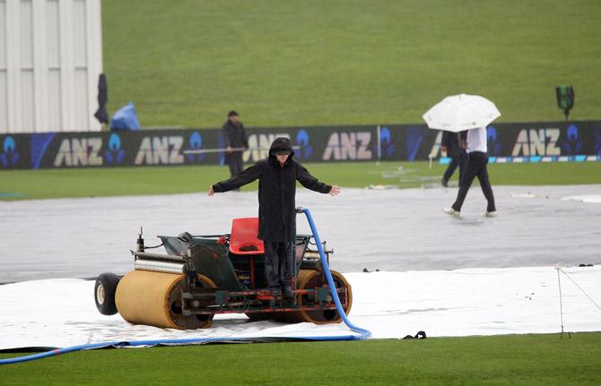 Rain delays the start of play during day five of the third Test cricket match between New Zealand. Pics/AFP