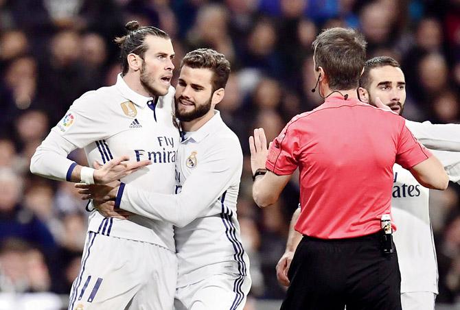 Real Madrid’s Gareth Bale (left) argues with the referee after being red-carded during the La Liga tie against Las Palmas at Bernabeu on Wednesday. Pic/AFP