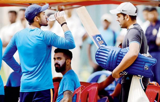 Rohit Sharma (right), who is undergoing rehab at the NCA, interacts with Karun Nair and KL Rahul during Team India’s practice session in Bangalore yesterday. Pic/PTI