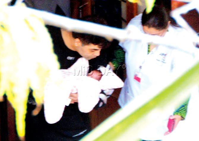 Filmmaker Karan Johar with one of his surrogate twins as he heads home with them on Tuesday. Pics/Sayyed Sameer Abedi