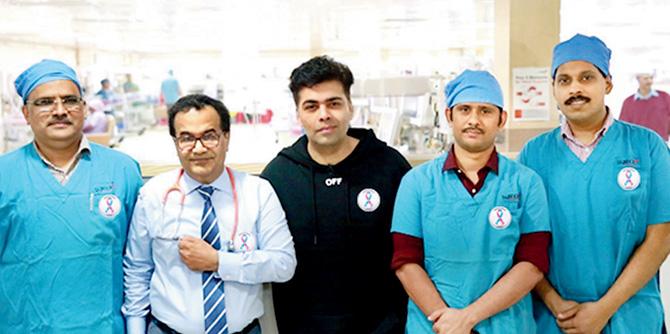Karan Johar (centre) with hospital doctors, all sporting the campaign badge