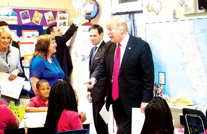 US President Donald Trump greets students as he tours Saint Andrew Catholic School in Orlando, Florida, on Friday. Pic/AFP