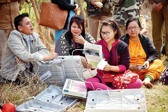Indian election officials examining Electronic Voting Machines (EVM) from a distribution centre on the eve of the State Assembly Election in Bishnupur district, some 46 km from Imphal, capital of Manipur. Results are expected on March 11. Pic/AFP