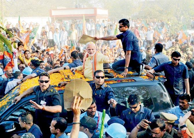 PM Narendra Modi during his second road show ahead of 7th phase of UP assembly elections in Varanasi. Pic/PTI