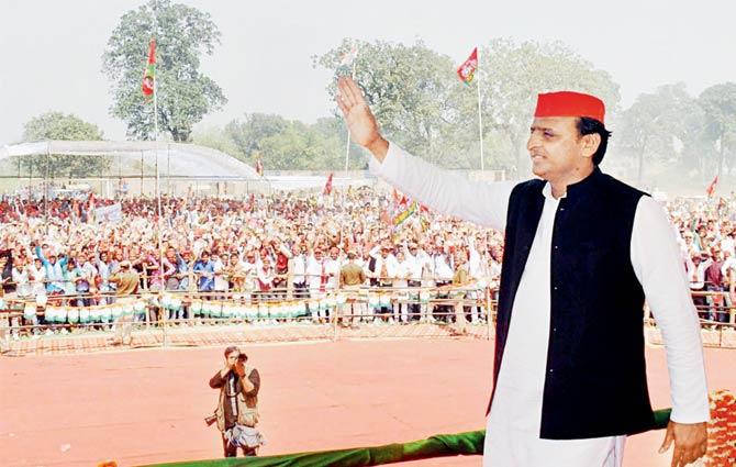 Akhilesh Yadav waves at people during his election rally in Ballia on Thursday
