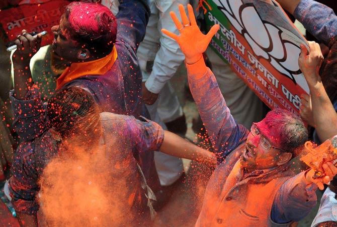 Indian supporters of the Bharatiya Janata Party (BJP) celebrate outside the party office as state assembly votes are counted in Lucknow. Pic/AFP