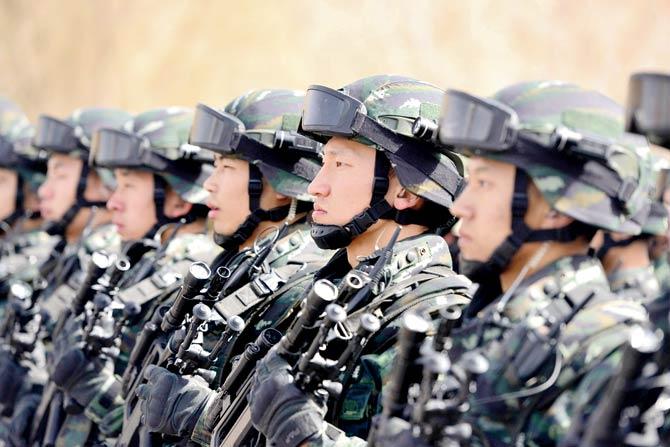 Chinese military police attending an anti-terrorist oath-taking rally in Hetian, in the Xinjiang Uighur Autonomous Region. Pic/AFP
