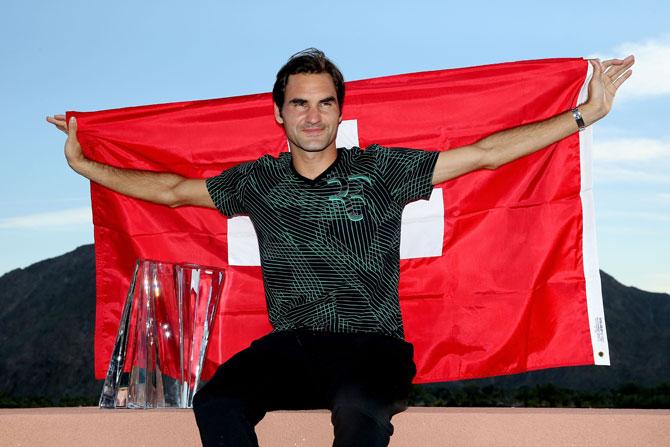  Roger Federer of Switzerland poses for photographers after defeating Stan Wawrinka of Switzerland during the men