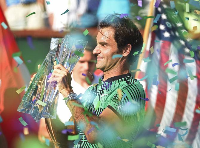 Roger Federer of Switzerland holds the BNP Paribas Open trophy 