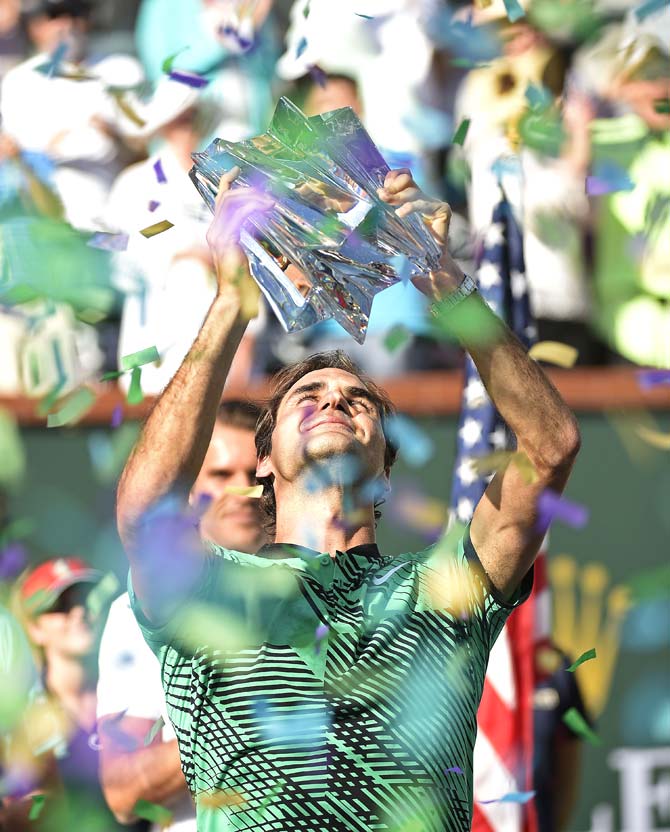 Roger Federer of Switzerland holds the BNP Paribas Open trophy 