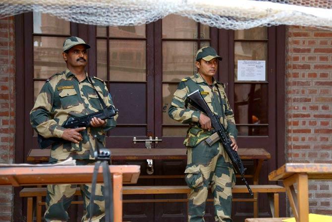 Indian soldiers stand guard outside a sealed 