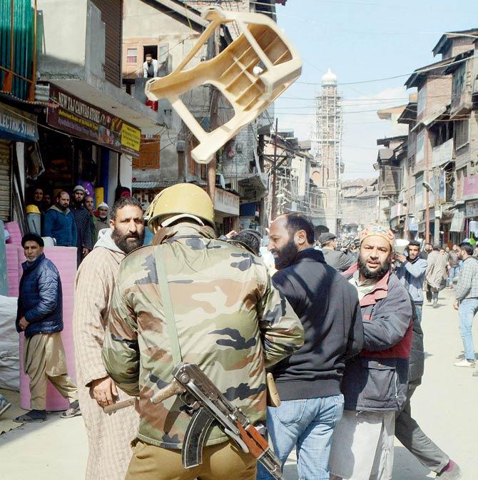 JKLF leaders throw a stool at a policeman after police stopped their march to protest against arrests yesterday. Pic/PTI
