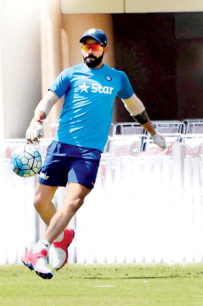 Team India skipper Virat Kohli plays football during a practice session in Ranchi yesterday. Pics/PTI