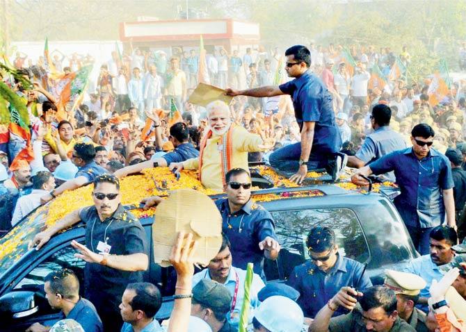 The crowd cheers for Prime Minister Narendra Modi during his road show in Varanasi yesterday. Pic/PTI