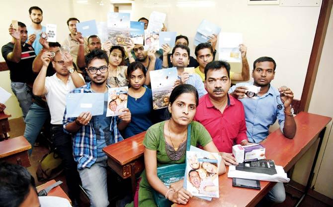 QNet scam victims display the fraudulent products that were sold to them