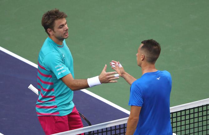 Stanislas Wawrinka of Switzerland shakes hands at the net after his straight sets victory against Philipp Kohlschreiber. Pics/AFP