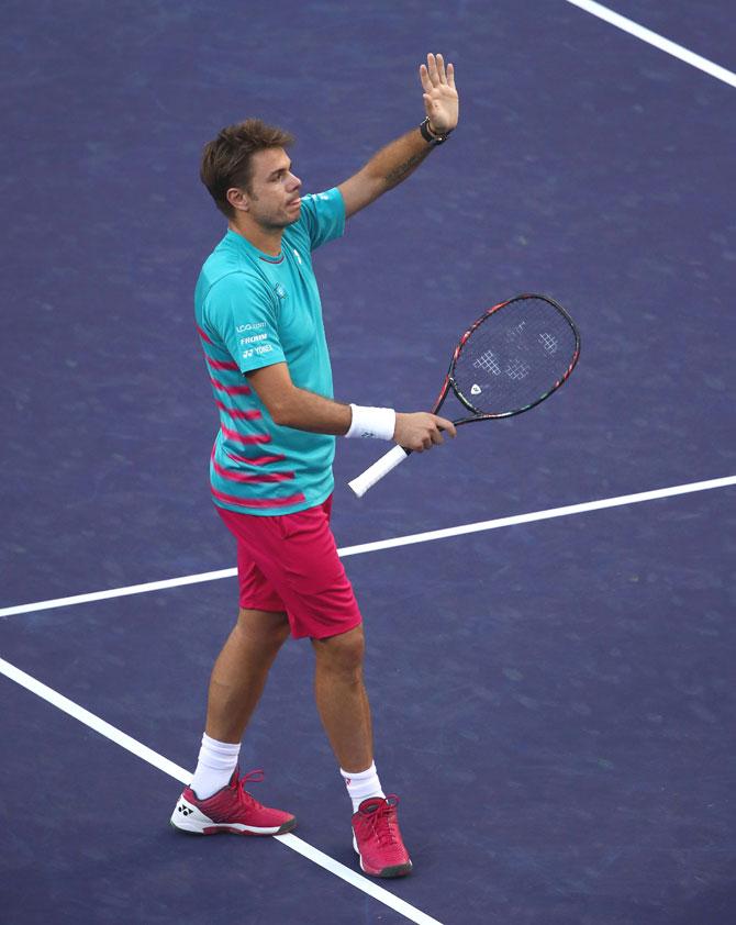 Stanislas Wawrinka of Switzerland waves to the crowd after his straight sets victory against Philipp Kohlschreiber