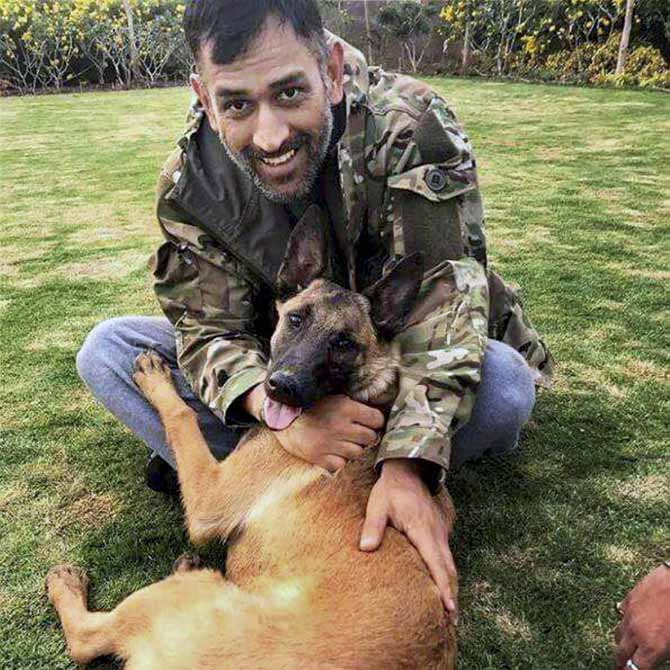 Mahendra Singh Dhoni with his dog at his residence in Ranchi on Thursday. PTI
