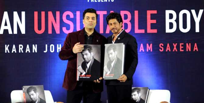 Bollywood film director and producer Karan Johar (left) and superstar Shah Rukh Khan pose during a promotional event for the book 