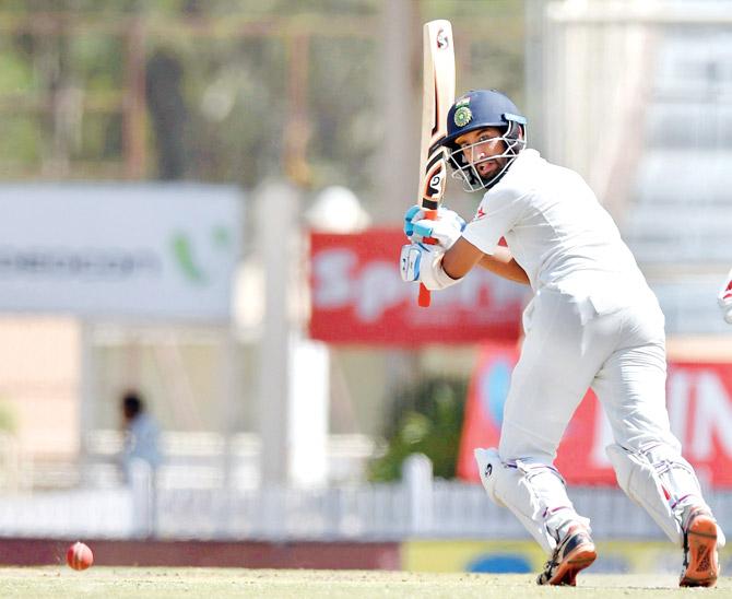 Cheteshwar Pujara plays one to the on-side during the third day