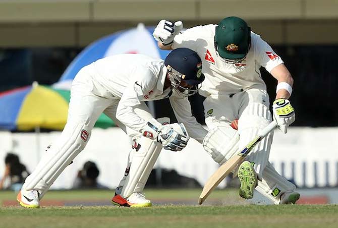 Wriddhiman Saha wrestles Stven Smith to the ground in trying to take a catch