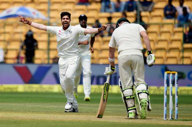 Umesh Yadav celebrates the wicket of Steve Smith during the fourth day of the second test match between India and Australia at Chinnaswamy stadium in Bengaluru on Tuesday. PTI