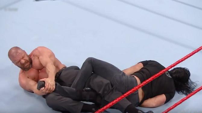 Triple H attacks Seth Rollins