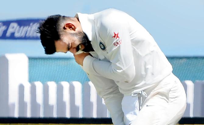India skipper Virat Kohli holds his shoulder after he was injured while fielding during the first day of the third Test against Australia in Ranchi yesterday. Pic/AFP