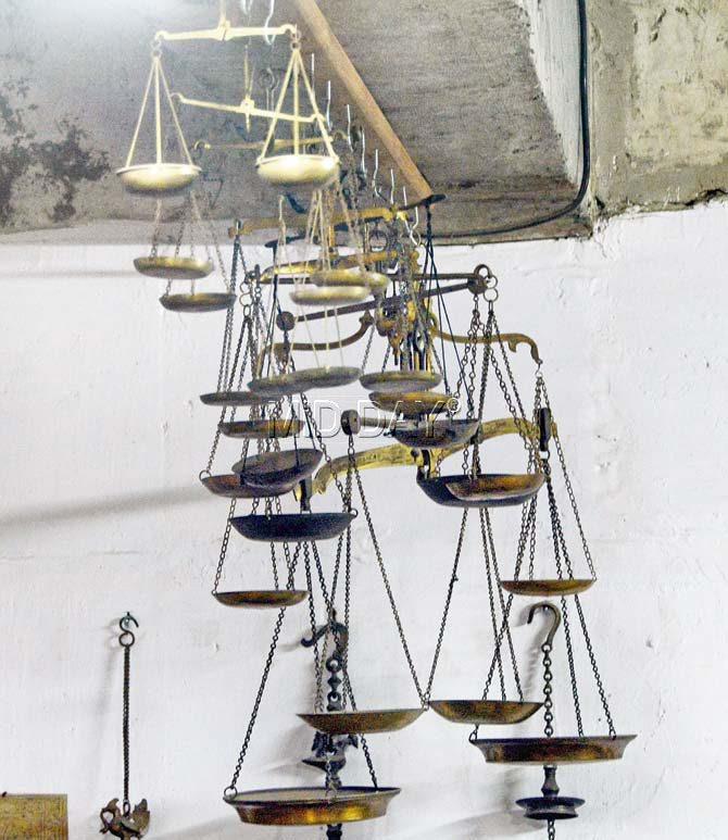 A set of ancient weighing scales hang from the ceiling